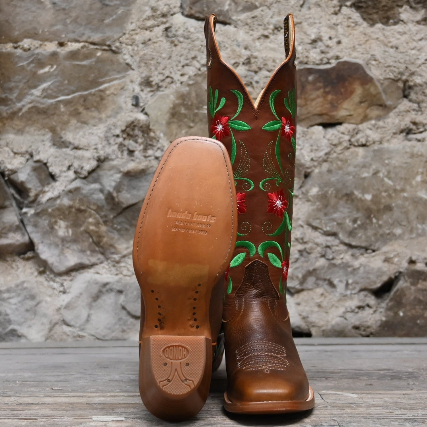 View of Hondo 16" cowboy boot with rust volcano top, red floral embroidery, rust oil tan vamp, and pull holes