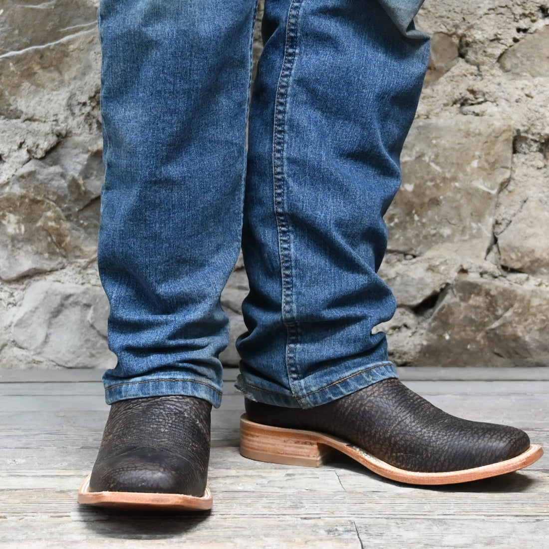 View of Hyer HAZELTON 11" boots showcasing black Apache bullhide leather vamp and tangerine vintage goat upper with broad square toe and Stockman block heel