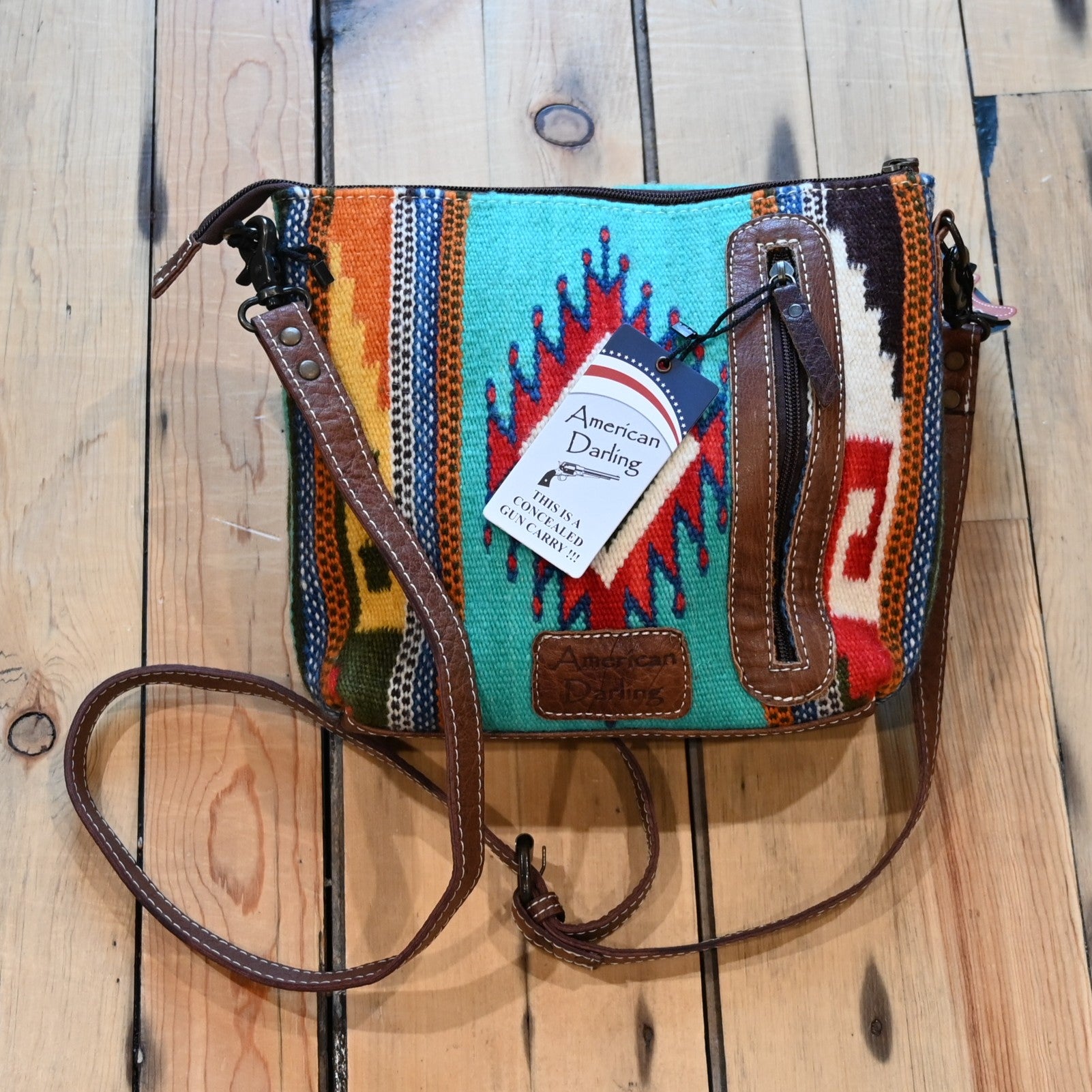 American Darling leather and saddle blanket crossbody bag in teal, red, orange, and brown with leather strap and conceal carry compartment