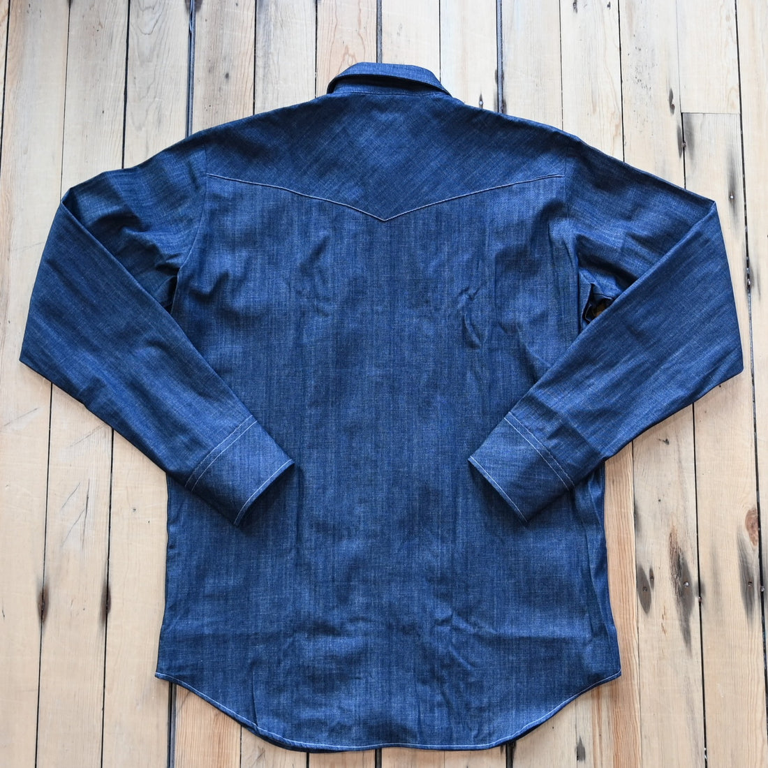 View of Blue Blanket men’s dark indigo denim Western shirt with pearl snap closures and yoke detailing