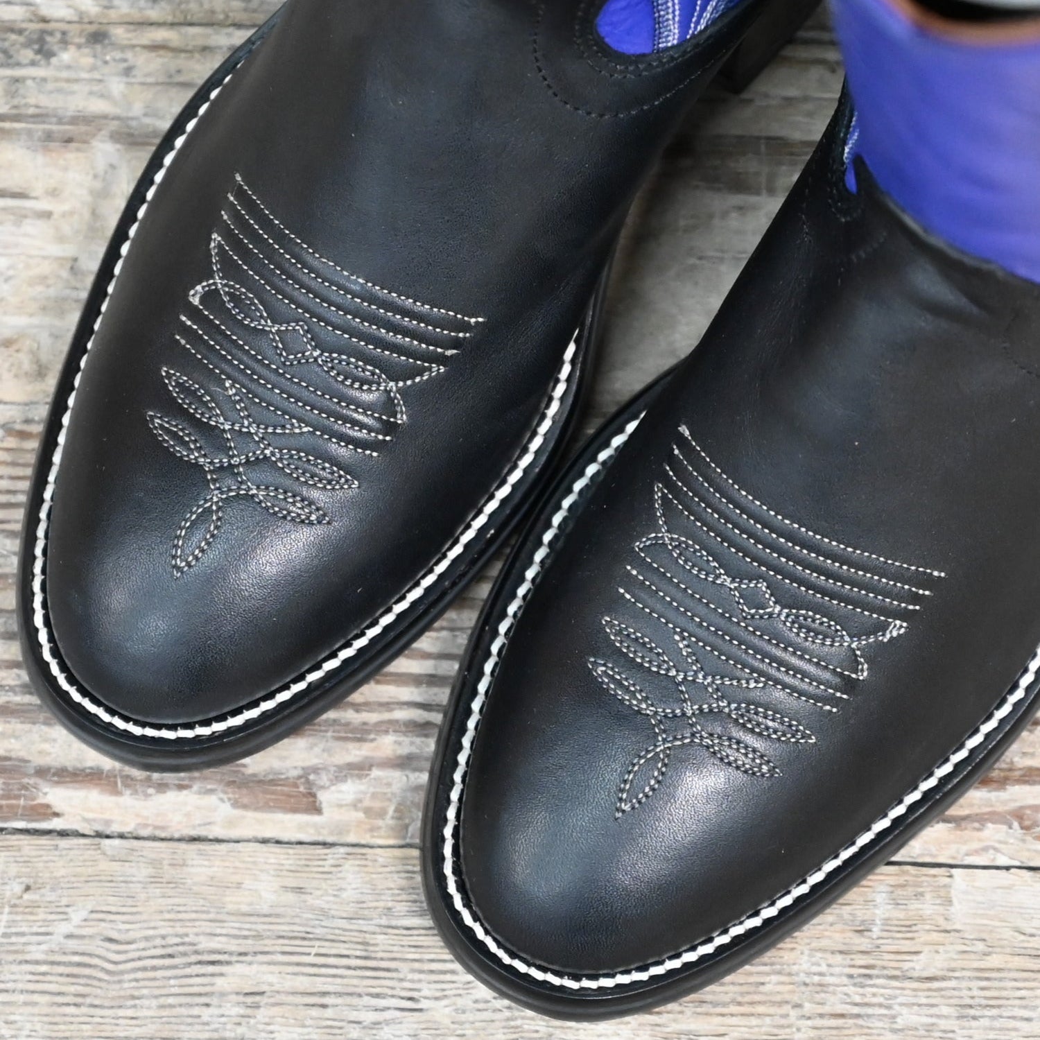 View of Hondo 16" cowboy boot with purple top, black retan vamp, pull holes, and spur ledge