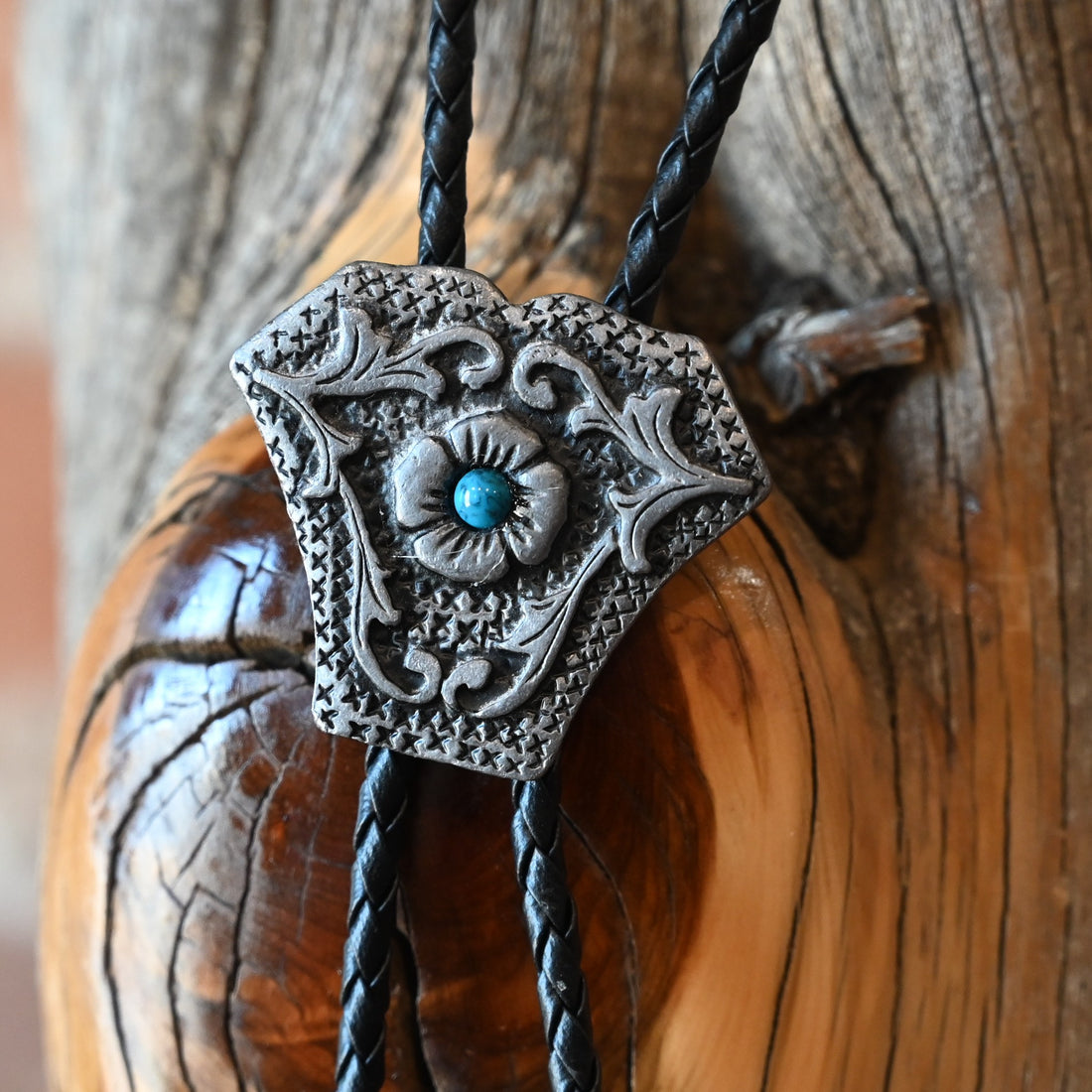 Rockmount Ranch Wear Shield Bolo with stone center and silver tips on black braided leather cord