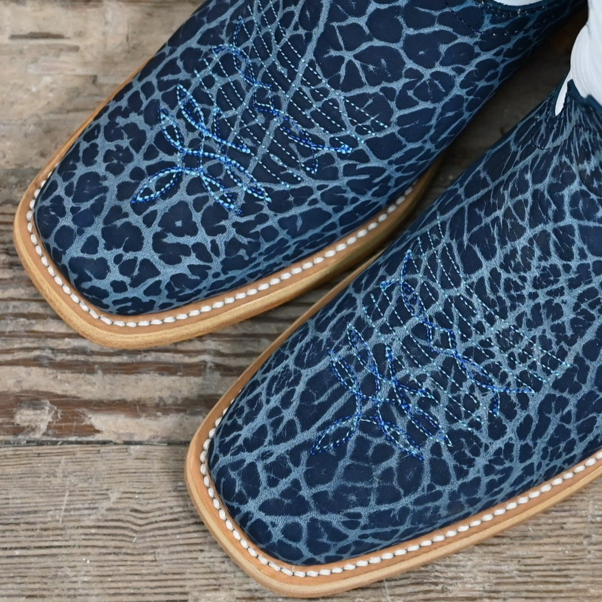 View of Hondo 13" cowboy boot with white top, navy nubuck bullhide vamp, blue stitching, snip toe, and spur ledge