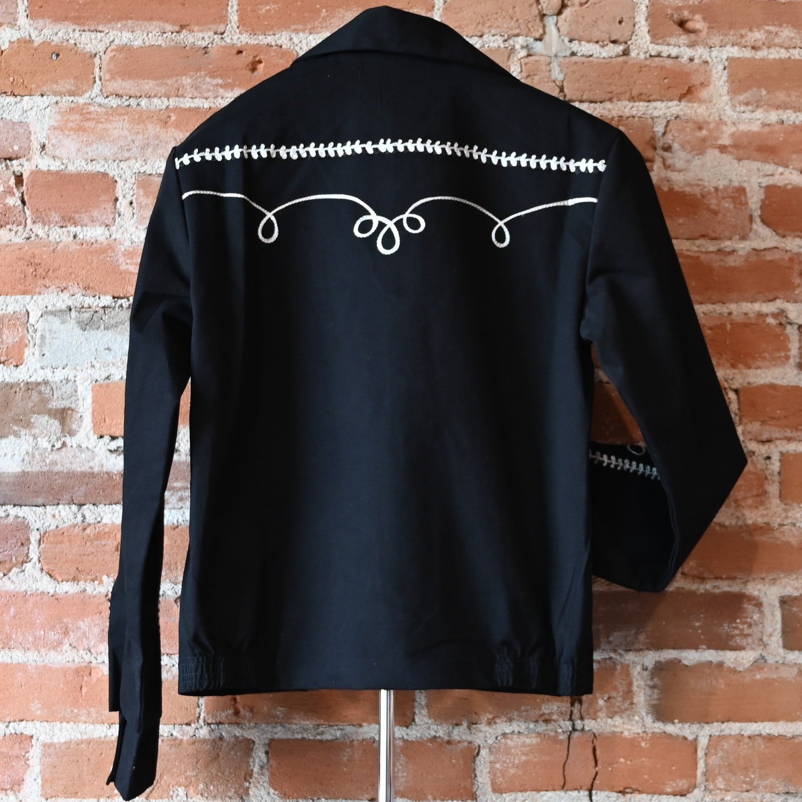 View of Rockmount vintage black gabardine bolero jacket with embroidery and snaps