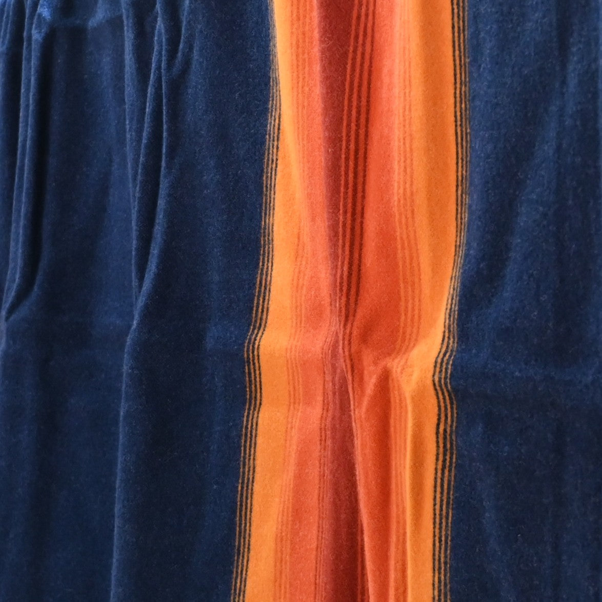 View of Pendleton National Park Blanket in Grand Canyon Navy with heritage stripes and park label