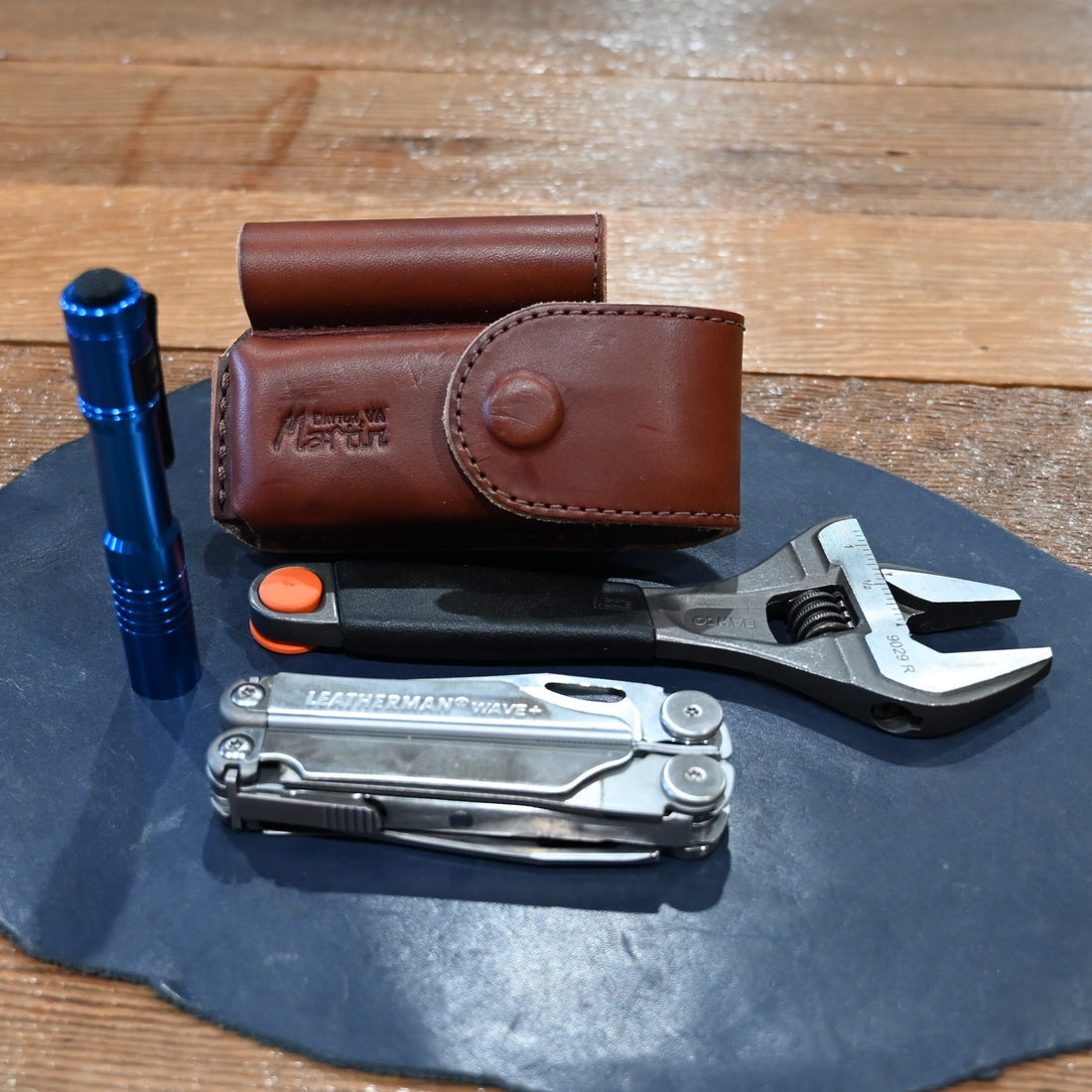 Martin harness leather case with flashlight, wrench, and Wave Leatherman tool combo