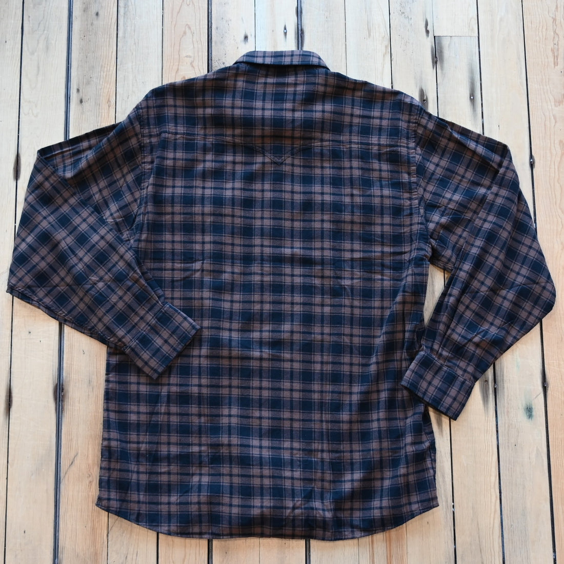 View of Schaefer bark black flannel shirt with button-down front and Western styling