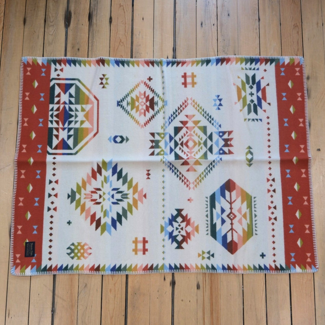 Pendleton Wild Blooms child-sized wool blanket in White/Coral Multi floral design.