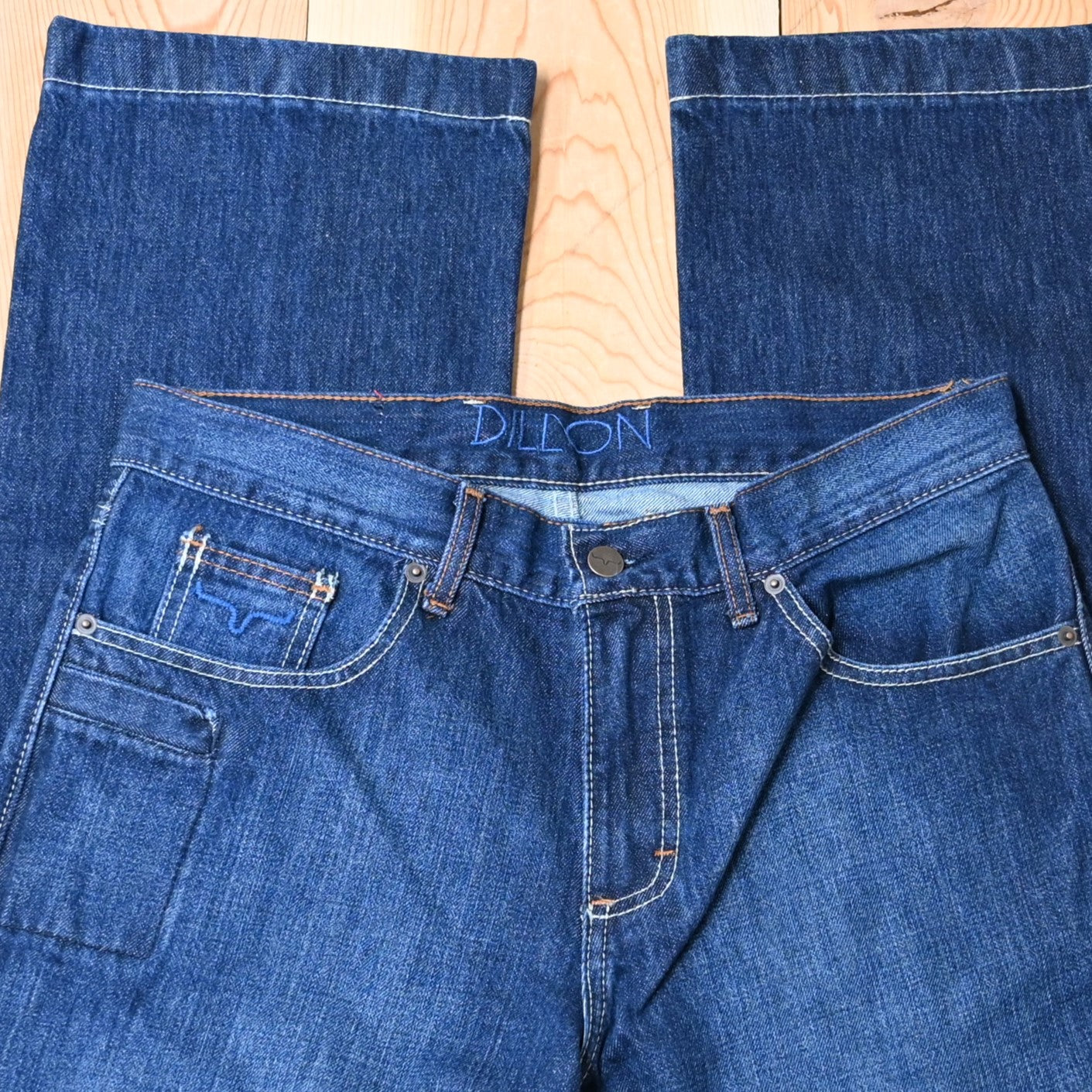 View of Kimes Ranch Dillon Jeans in Blue, featuring a mid-low rise, relaxed upper thigh, and wide bootcut leg with hand-sanded details
