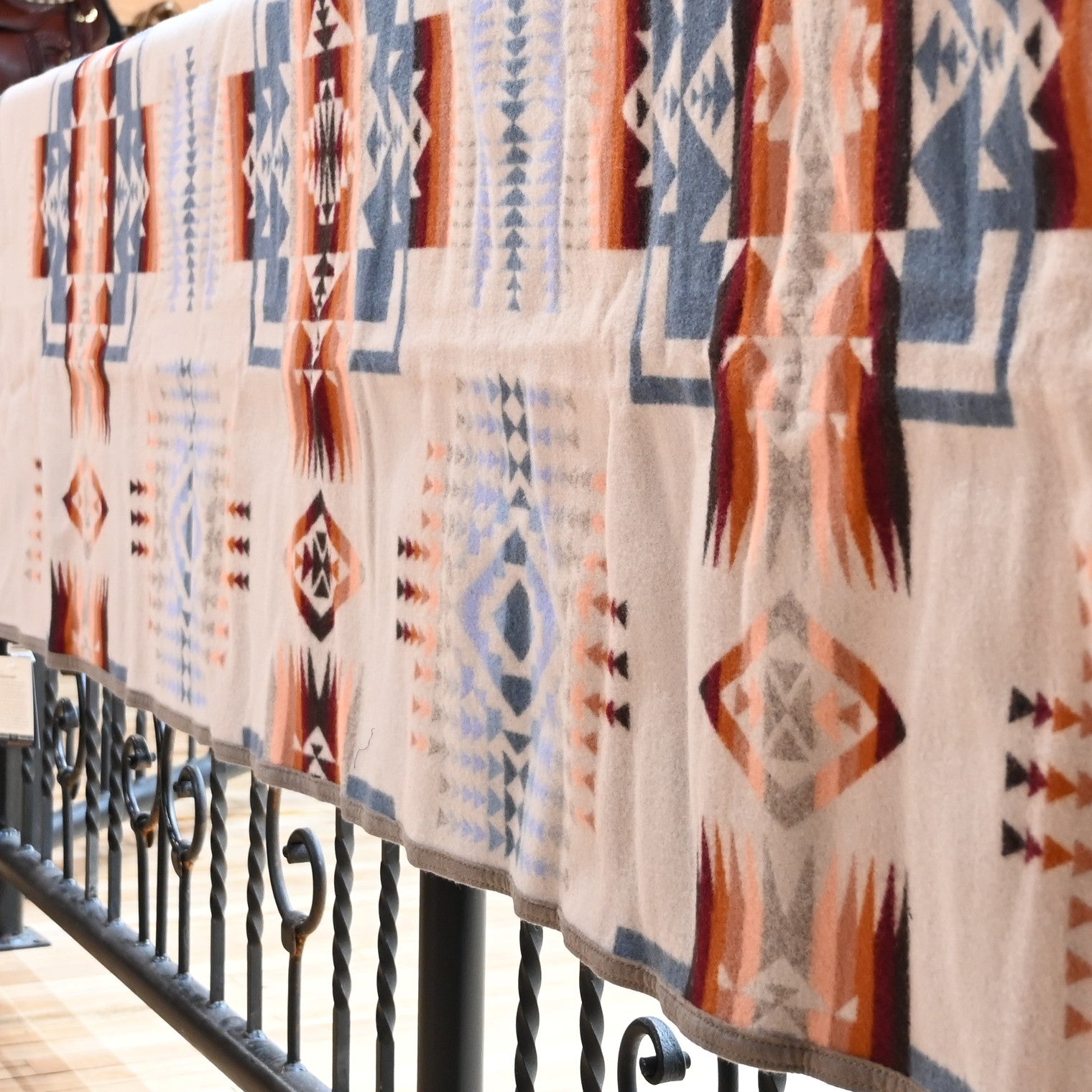 View of Pendleton Chief Joseph Rosewood queen blanket in soft blue, cream, and pink tones