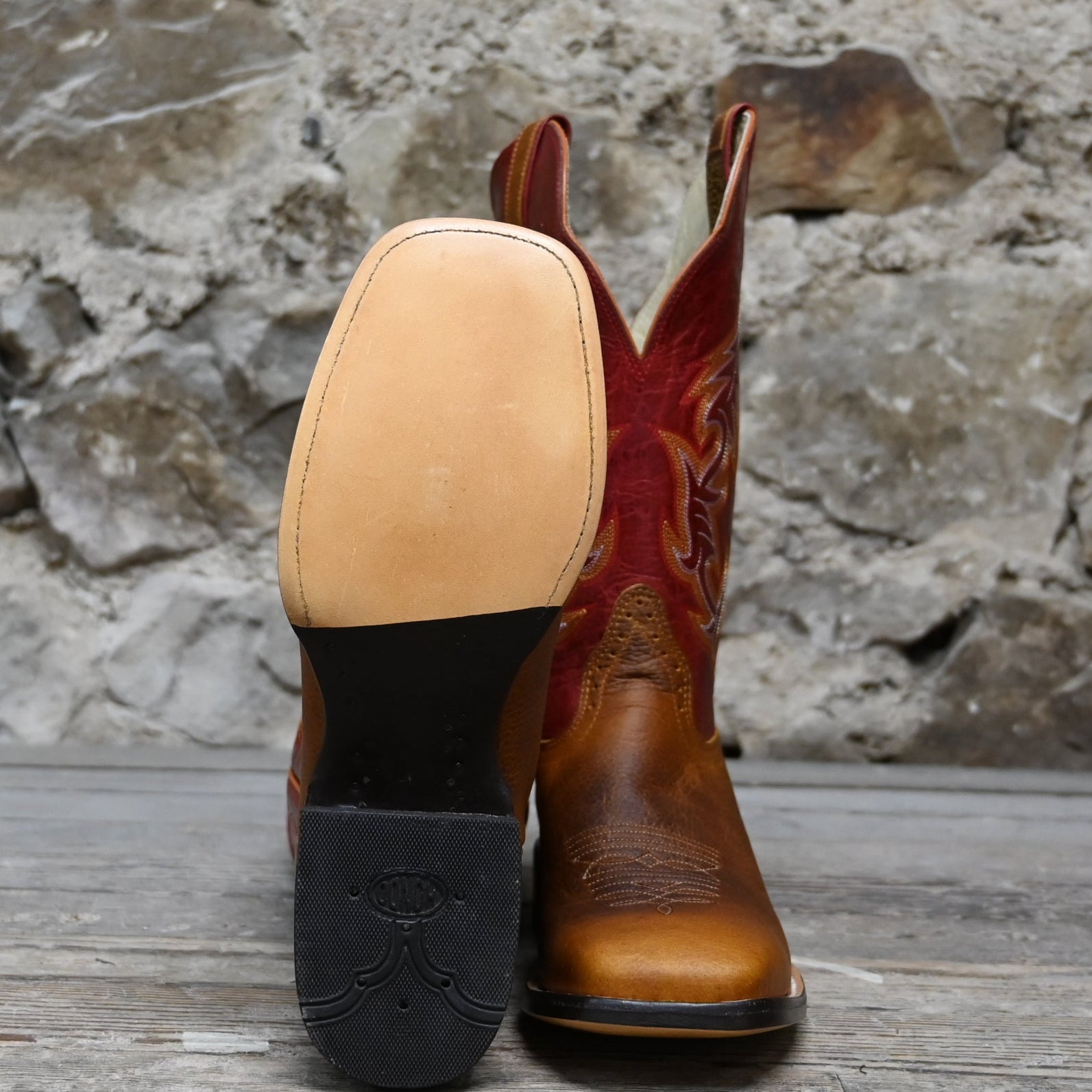 View of Hondo 13" cowboy boot with red volcano top, rust oil tan vamp, wide square toe, and spur ledge