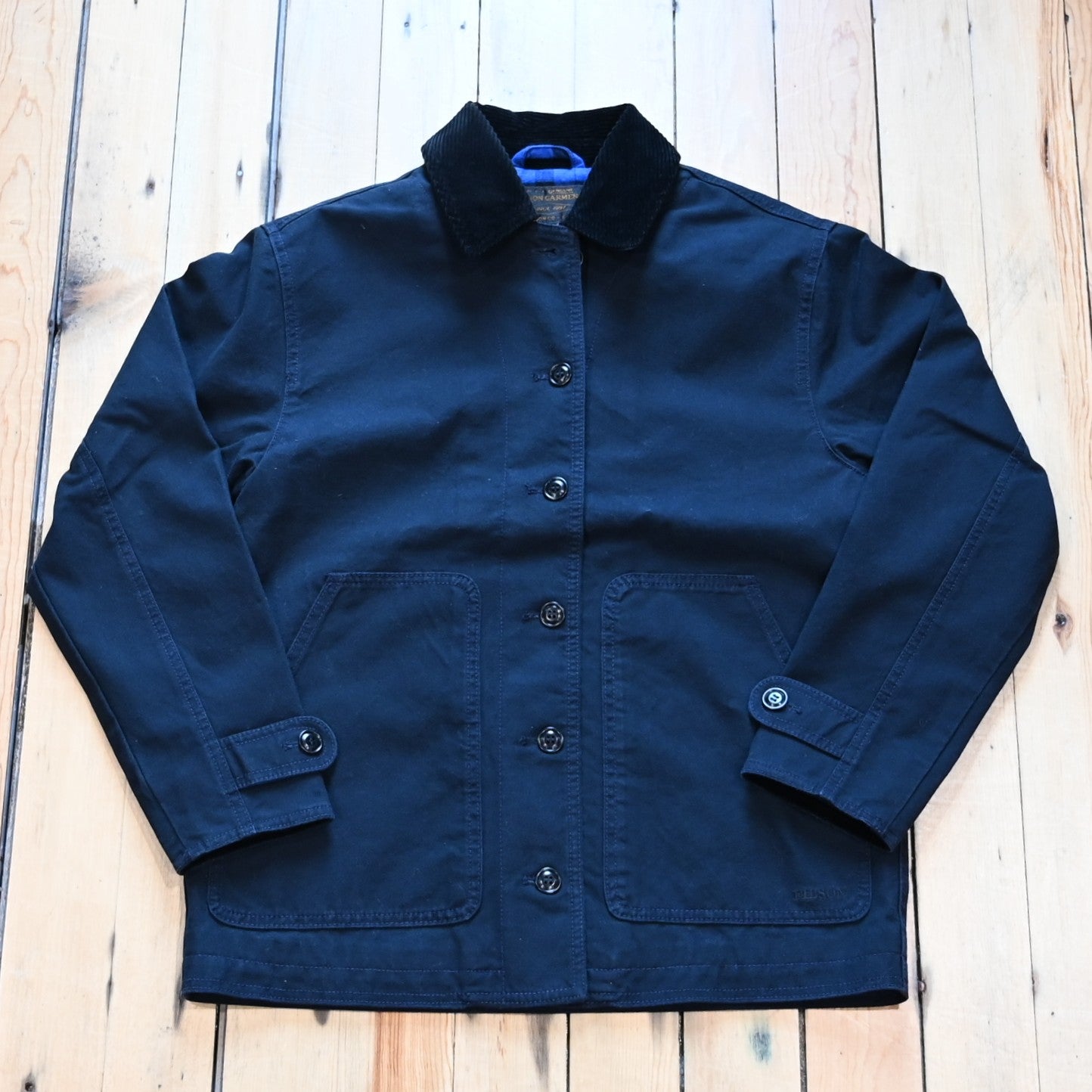 Filson women’s barn coat in navy canvas with corduroy collar and patch pockets