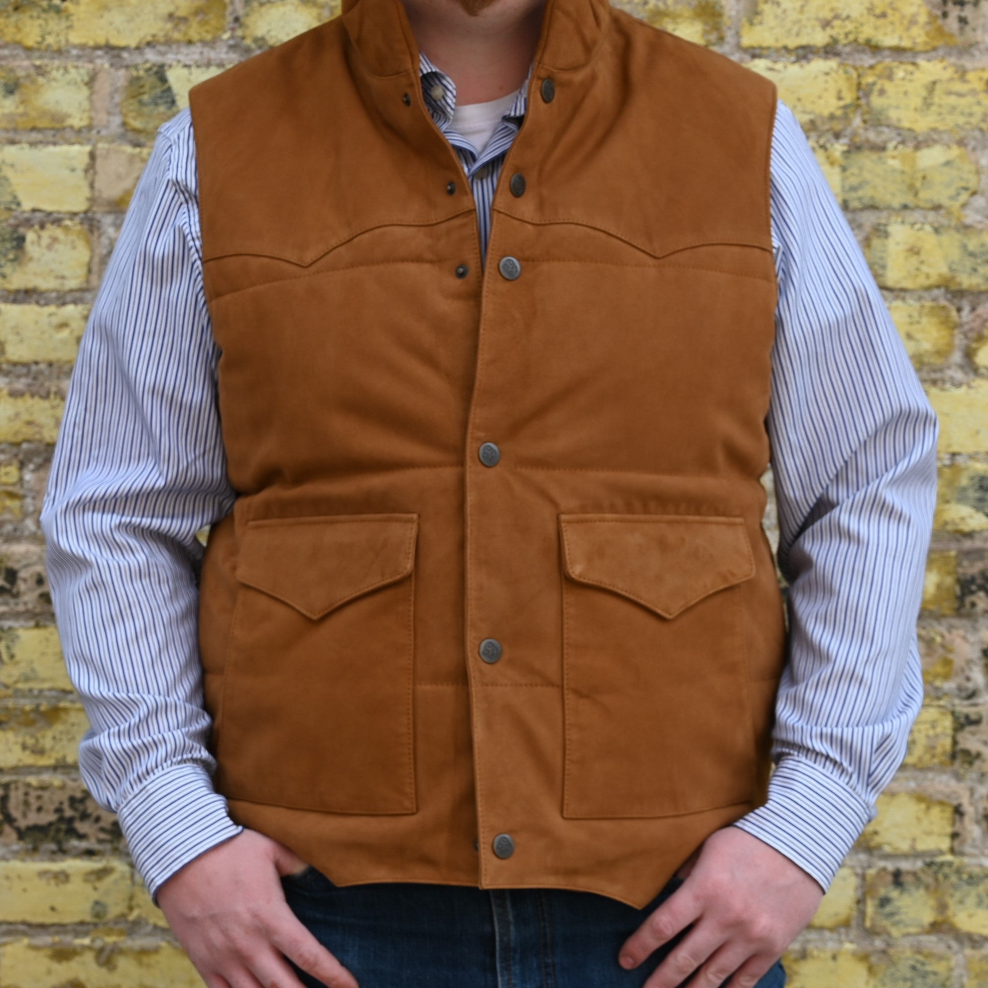 View of Schaefer men’s honey suede vest with Western yoke, fleece-lined pockets, and brass snap closure