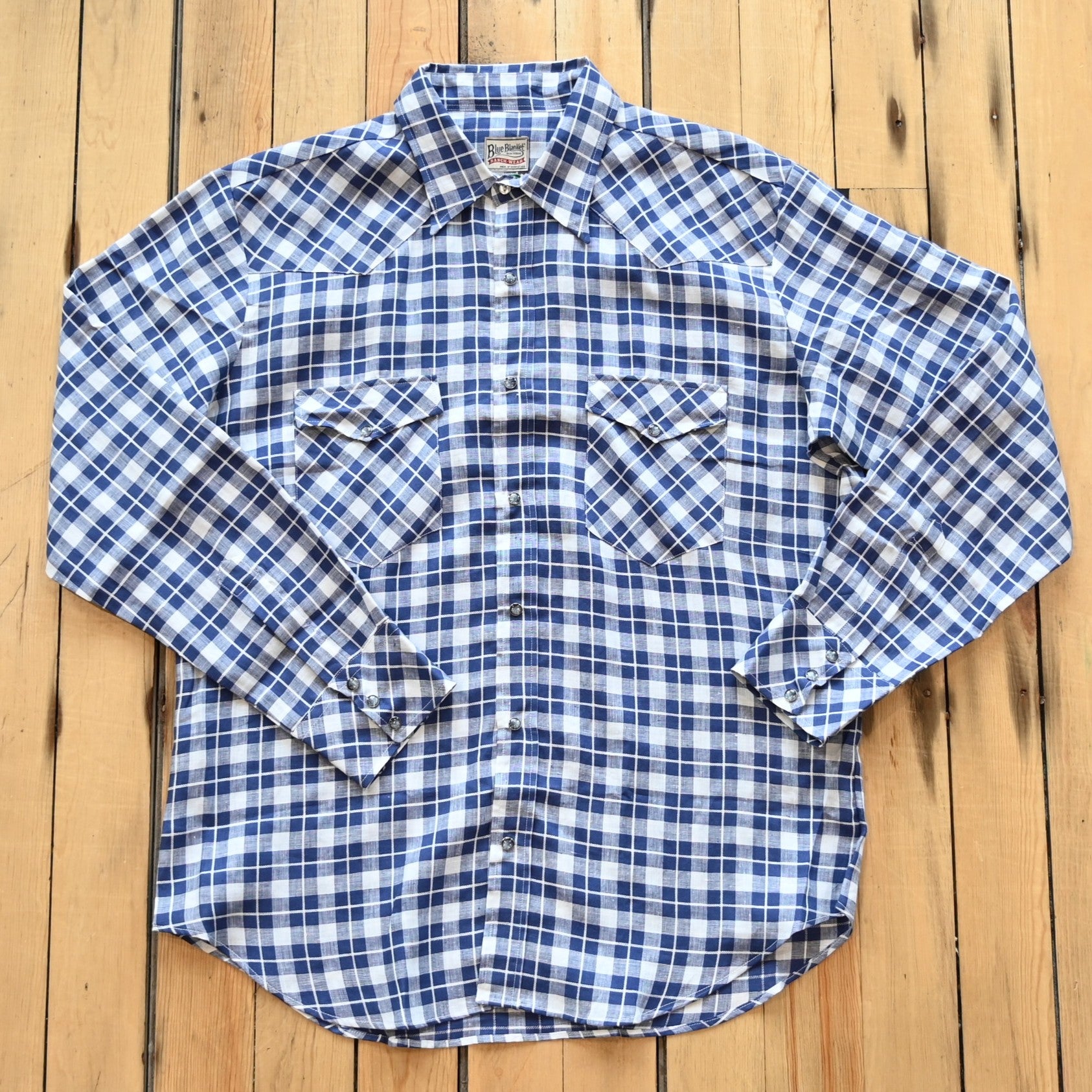 View of Blue Blanket men’s blue plaid linen Western shirt with pearl snaps and yoke detail
