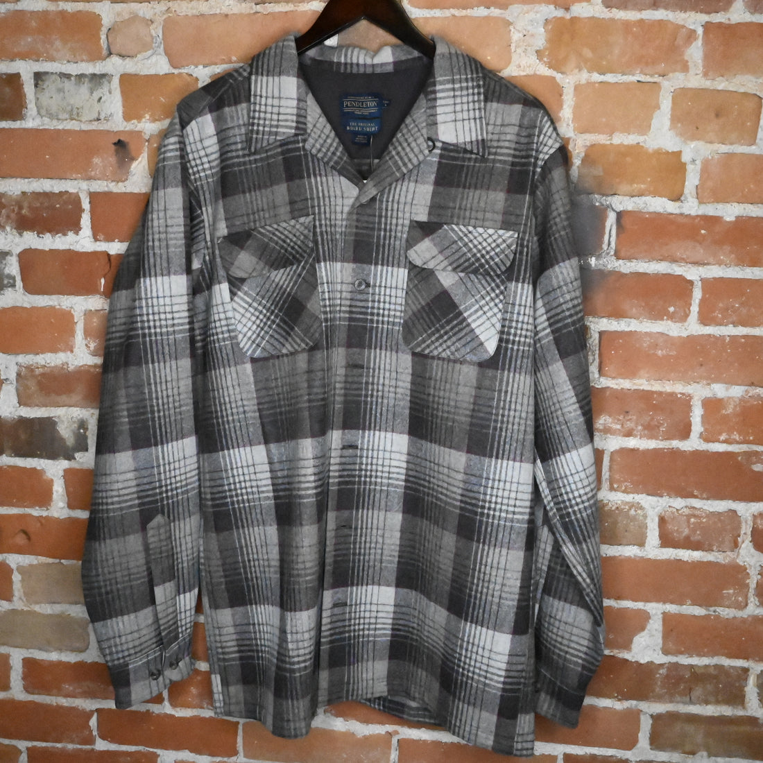View of Pendleton men’s tall black and grey plaid wool board shirt with square hem