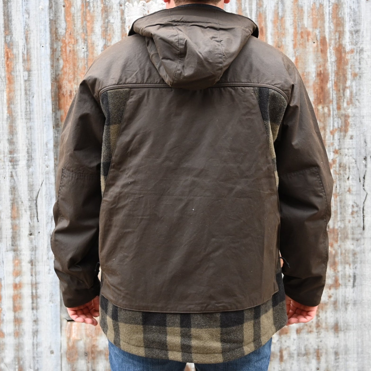 View of Filson Mackinaw Wool Hunting Jacket in Otter Green/Black Plaid featuring oil-finish Cover Cloth overlays and fleece-lined pockets