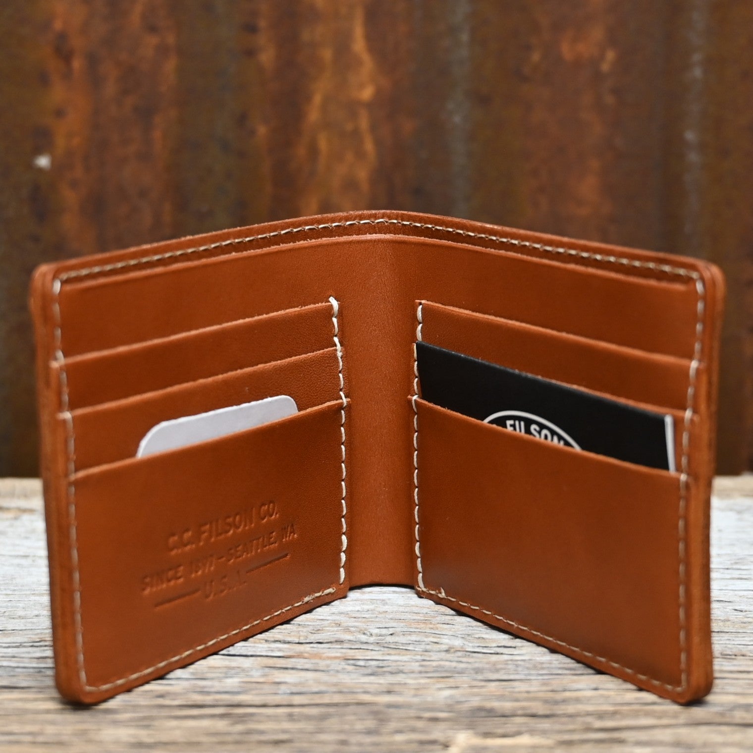 View of Filson Leather Bi-Fold Wallet in Tan featuring six card slots and a cash compartment