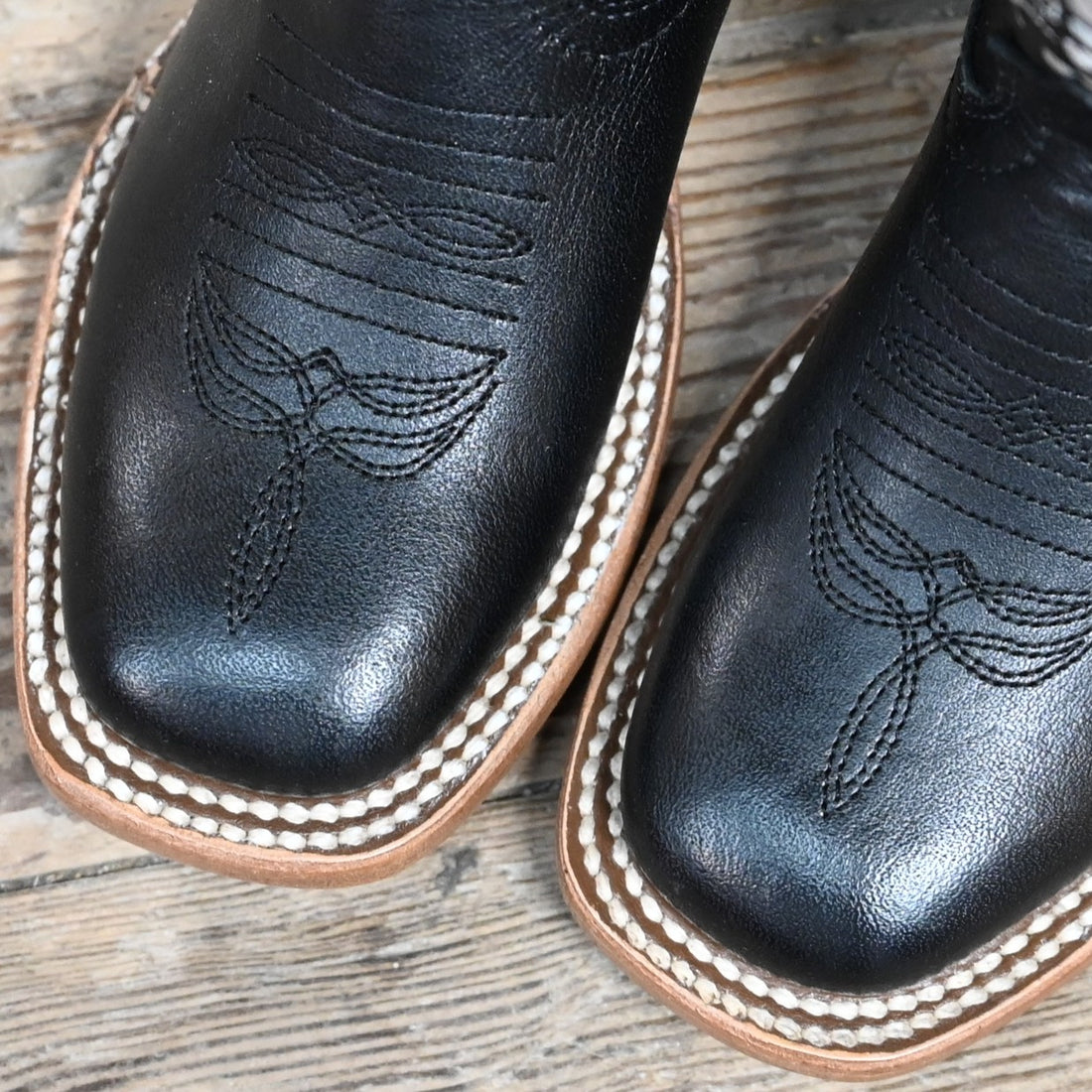 View of Macie Bean Kids Black Eyed Susan boot with black leather and white floral stitching