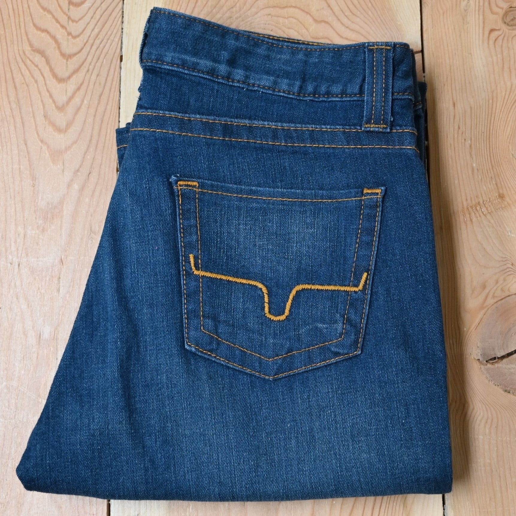 View of Kimes Ranch Betty17 Jeans in Blue, featuring embroidered horns on back pockets and a modest bootcut leg