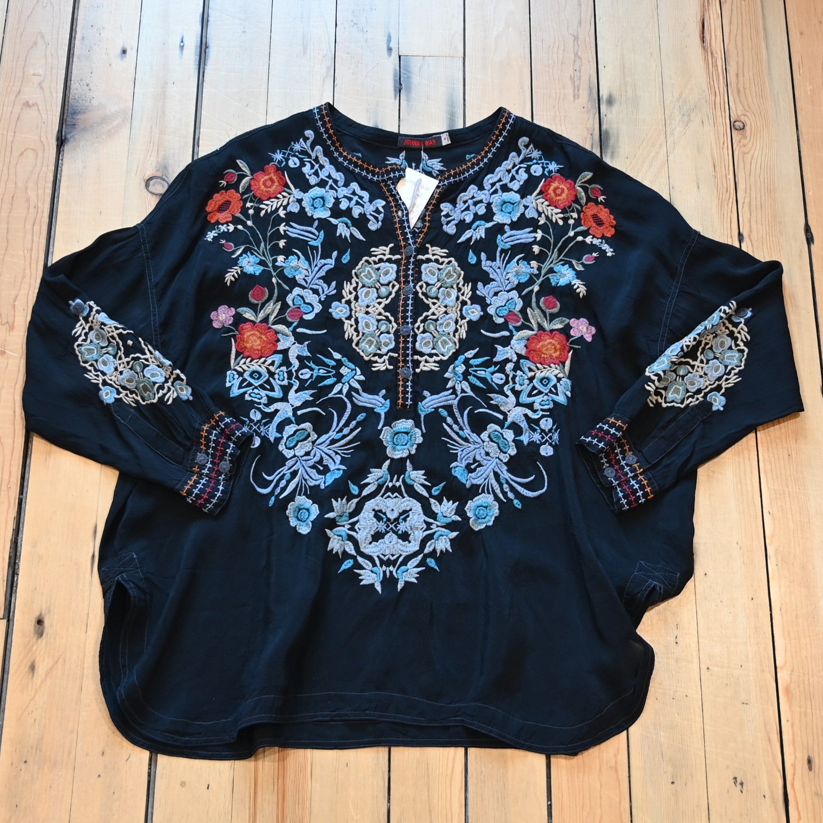 View of Johnny Was sanded black blouse with tonal embroidery on front and shoulders