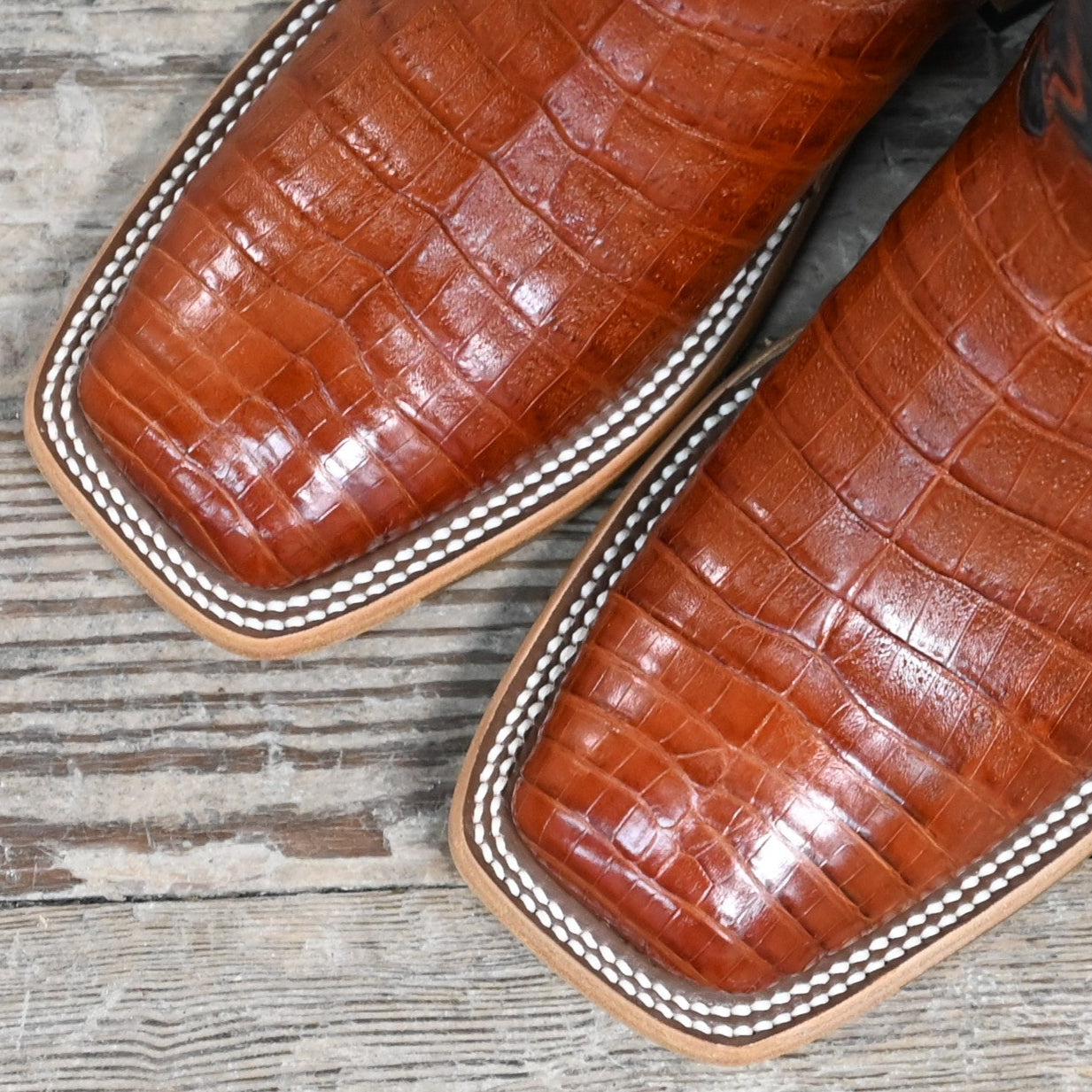 View of Macie Bean 12″ boot with blue shaft and brandy caiman belly vamp, DB toe and roper heel