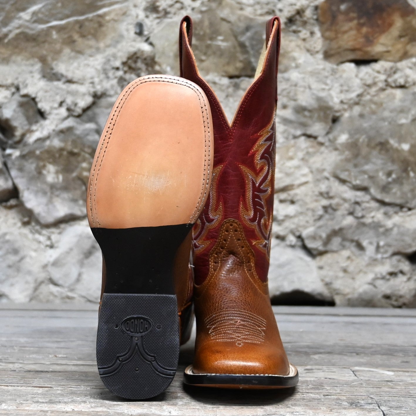 View of Hondo 13" cowboy boot with red volcano top, rust oil tan vamp, and wide square toe
