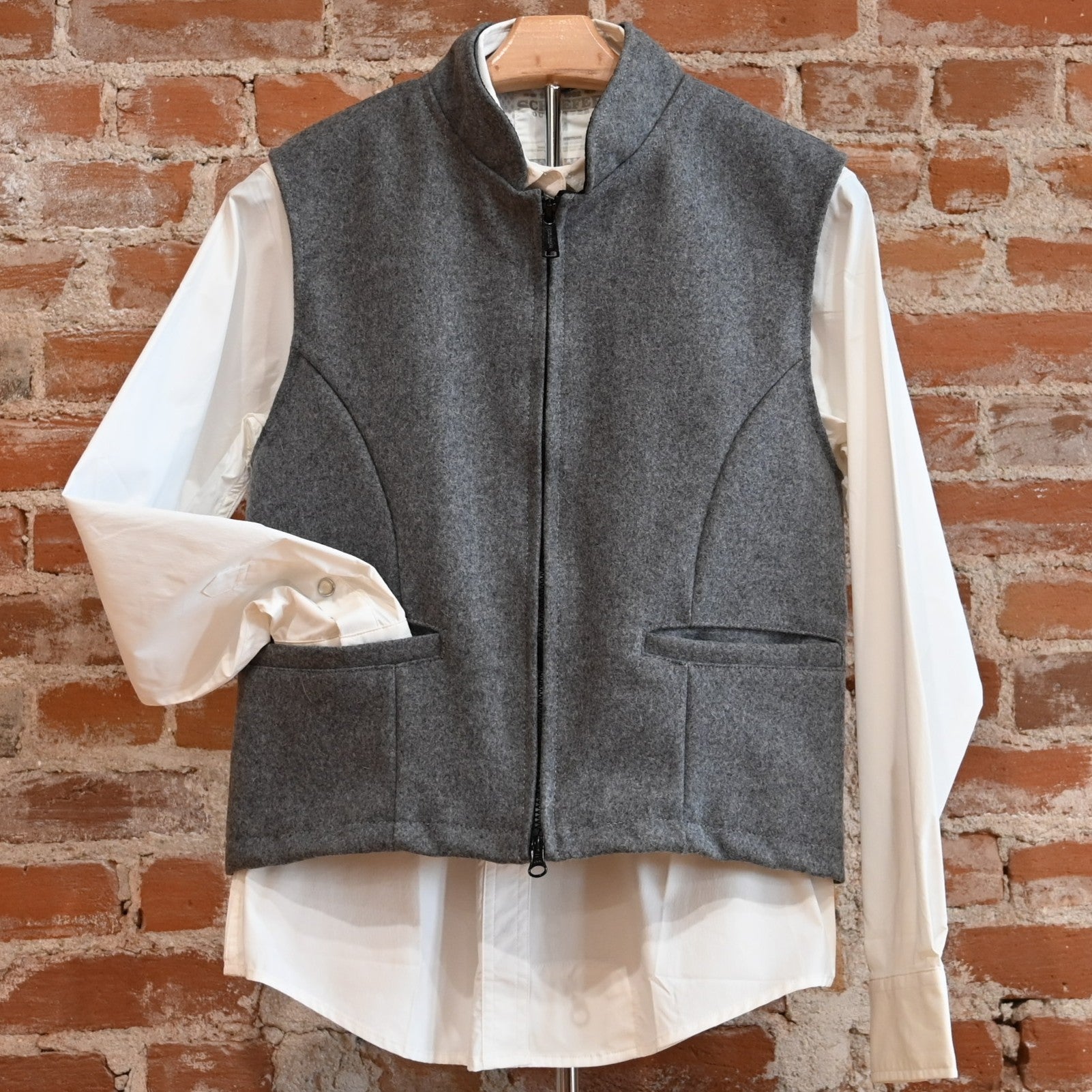 View of Schaefer grey wool vest with zip front, pockets, and adjustable back belt