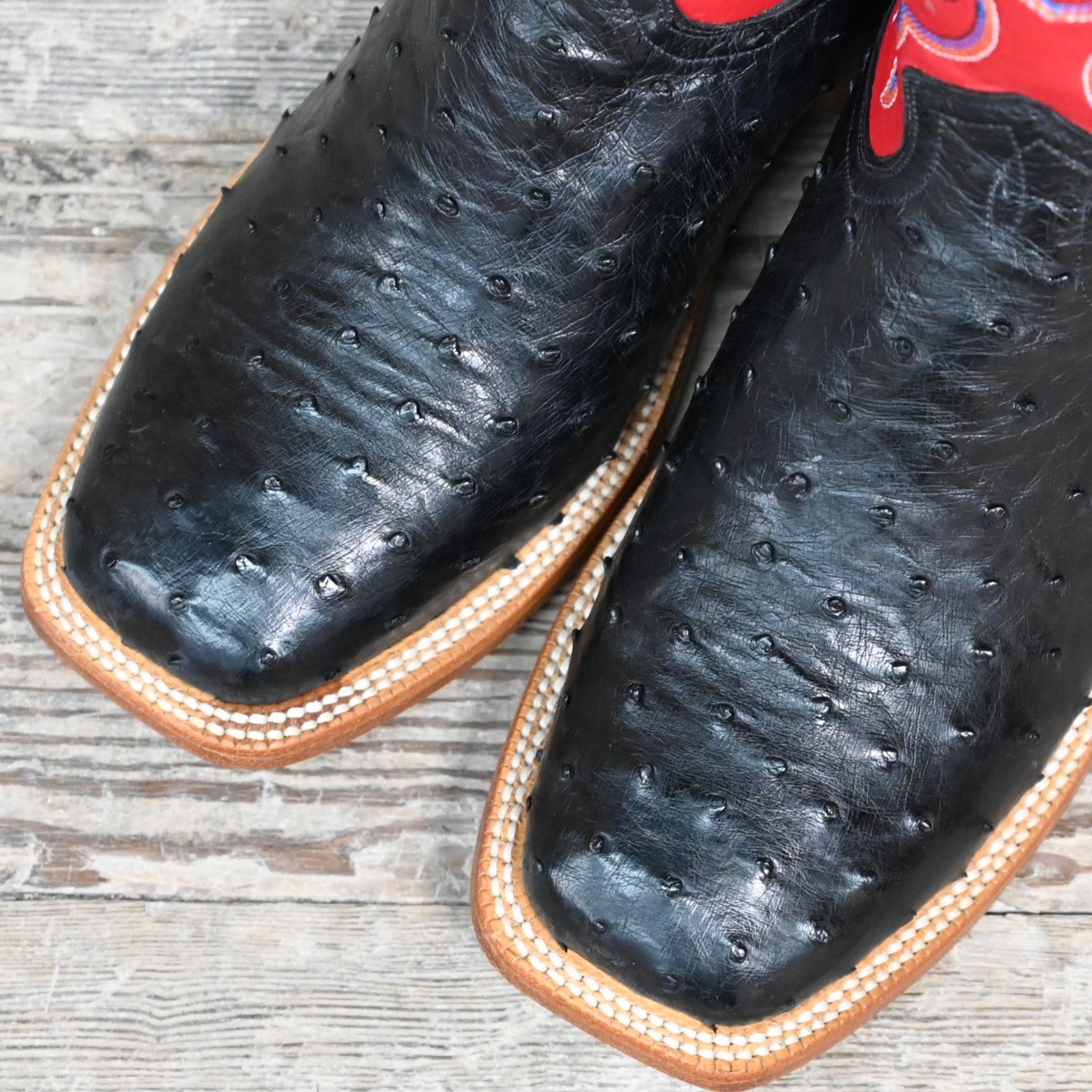View of Hyer JETMORE 13" boots showcasing black full-quill ostrich vamp and red vintage goat upper with broad square toe and Stockman block heel