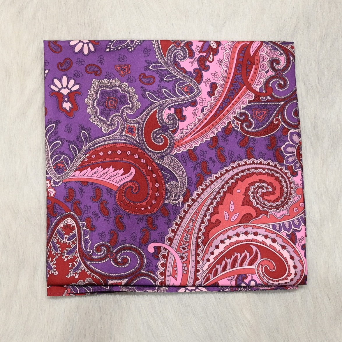 View of Purple and burgundy paisley silk wild rag with rolled edges