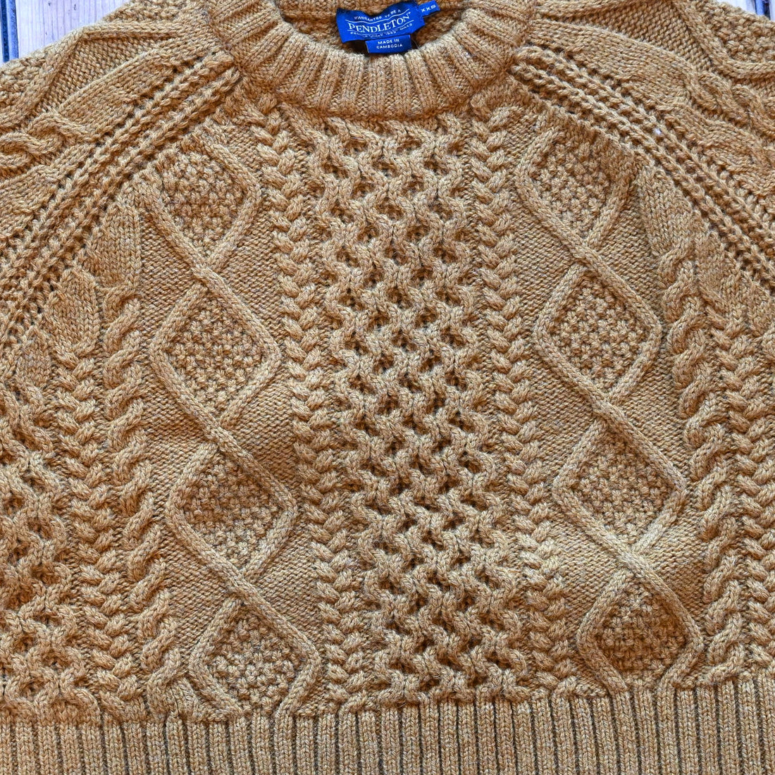 View of Pendleton cropped lambswool sweater in Deep Gold with cable knit pattern