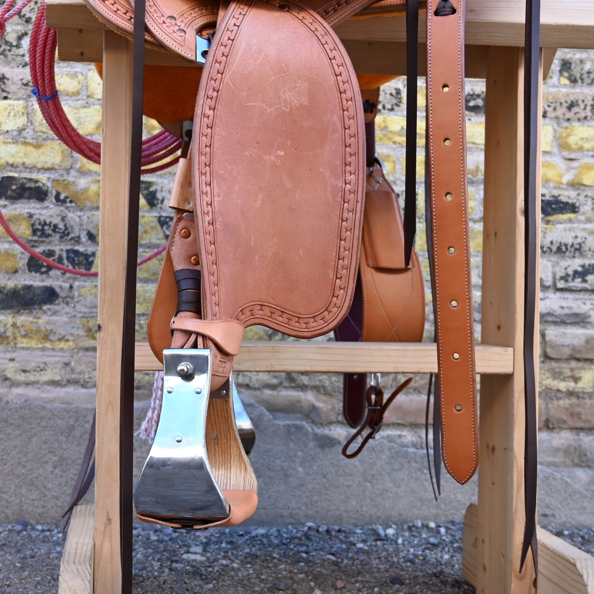 View of Deeter 3B Visalia Roughout Saddle with floral stamping and post horn