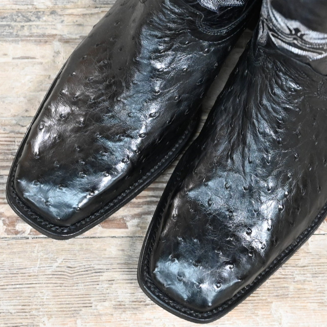 View of Hondo full quill black ostrich boot with black volcano top, 13" height, and pull straps