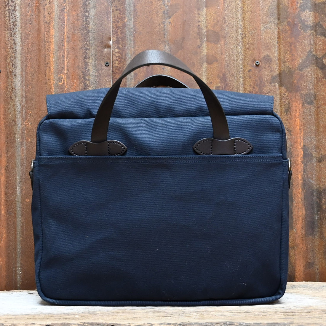 View of Filson Original Briefcase in Navy, showcasing rugged twill fabric and bridle leather accents