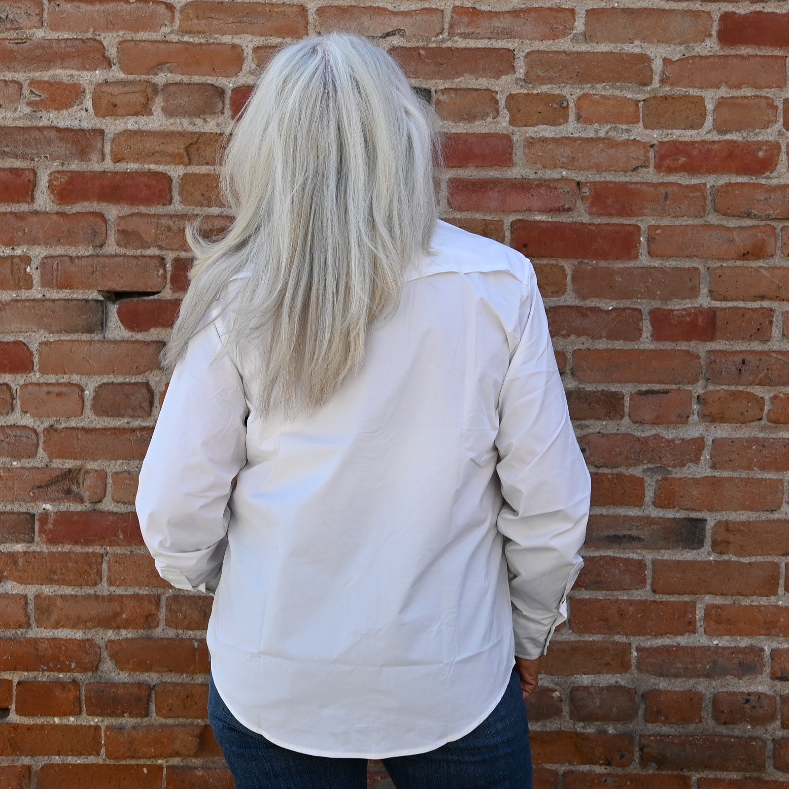 View of Schaefer white Range Tek shirt with snap front, mesh back vent, and functional chest pockets