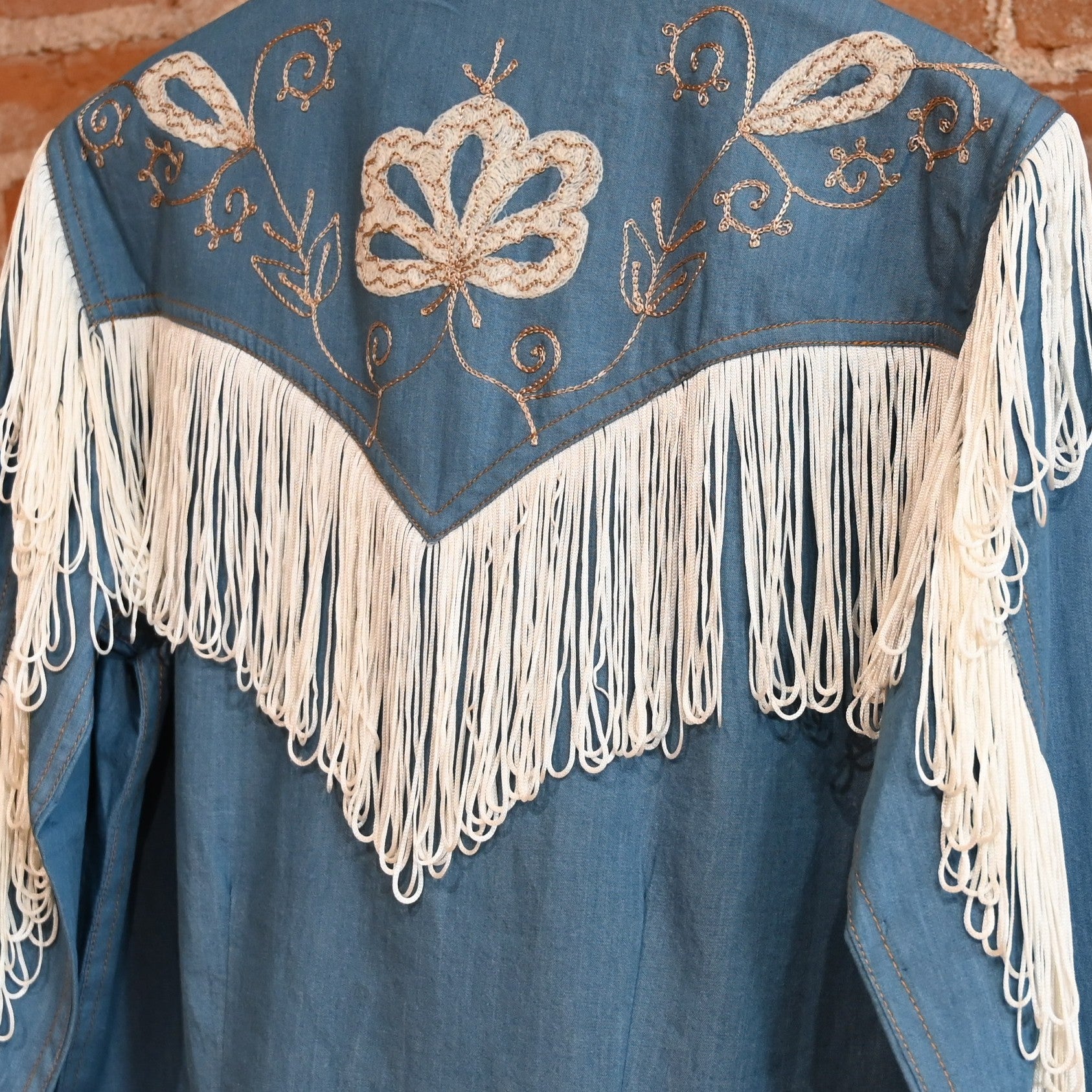 View of Rockmount ladies denim Western dress with fringe and floral embroidery