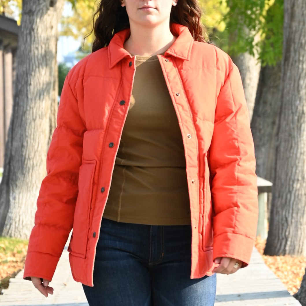 View of Filson Ladies Waxed Down Barn Coat in Campfire featuring antique-finish brass snaps and microfleece-lined hand pockets