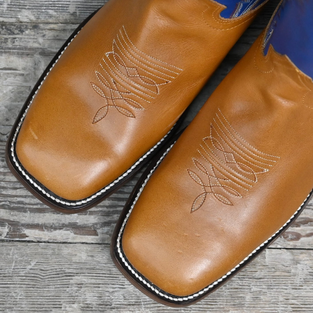 View of Hondo 16" cowboy boot with blue top, honey crazy horse vamp, wide square toe, and spur ledge