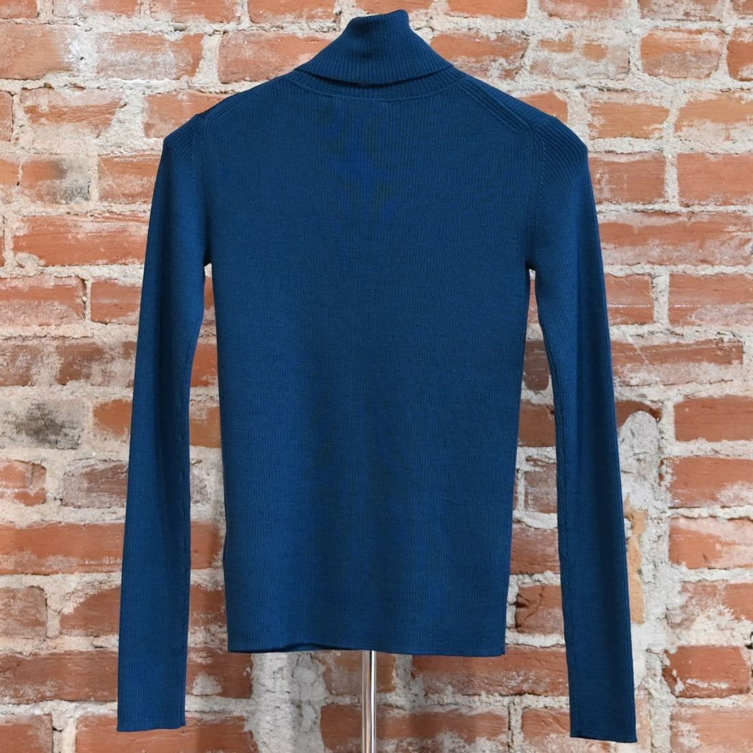 View of Pendleton rib merino turtleneck in Peacock Blue with slim fit and folded neck