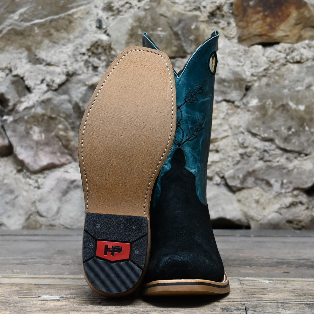 View of Horse Power 11" boot with black suede vamp, blue volcano shank and top, cutter toe, and pull holes