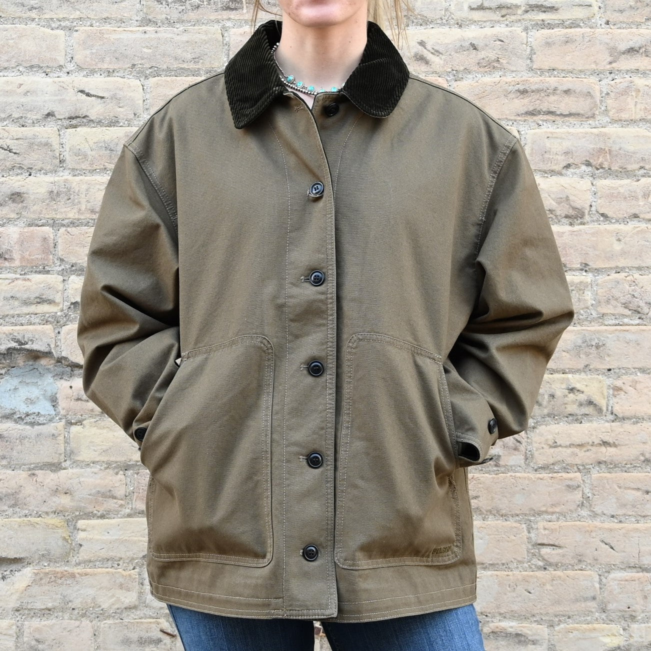 View of Filson Ladies Barn Coat in Marsh Olive featuring button-front closure and corduroy-lined collar