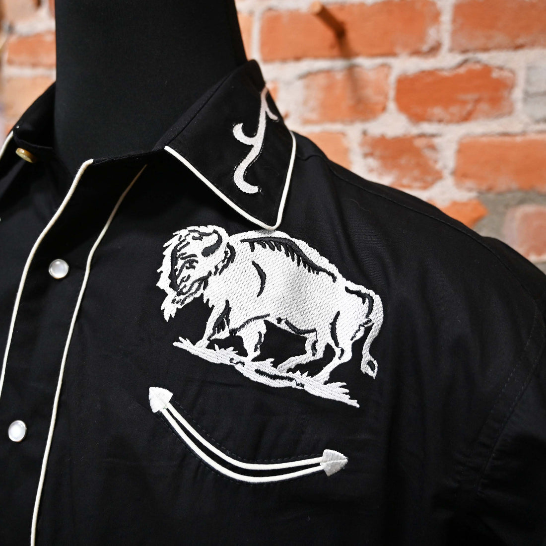 View of Black Western shirt with white embroidered bison motif across yokes
