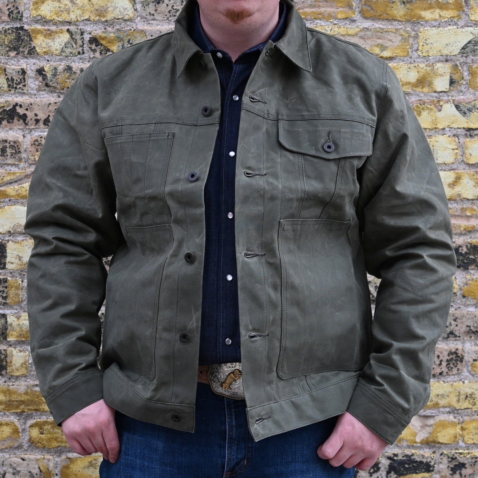 View of Filson Tin Cloth Short Lined Cruiser Jacket in Assorted Colors, showcasing durable waxed cotton exterior and adjustable cuffs and hem