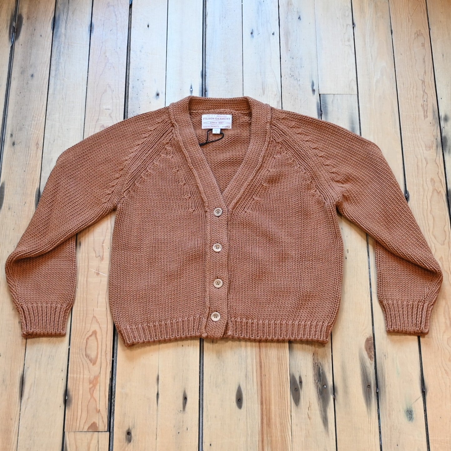 View of Filson Ladies Rustic Cotton Cardigan in Chestnut featuring a V-neckline and four-button front closure