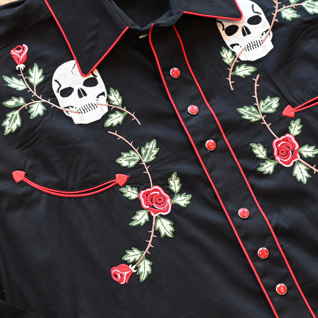 View of Black Western shirt with skull and rose embroidery and red piping