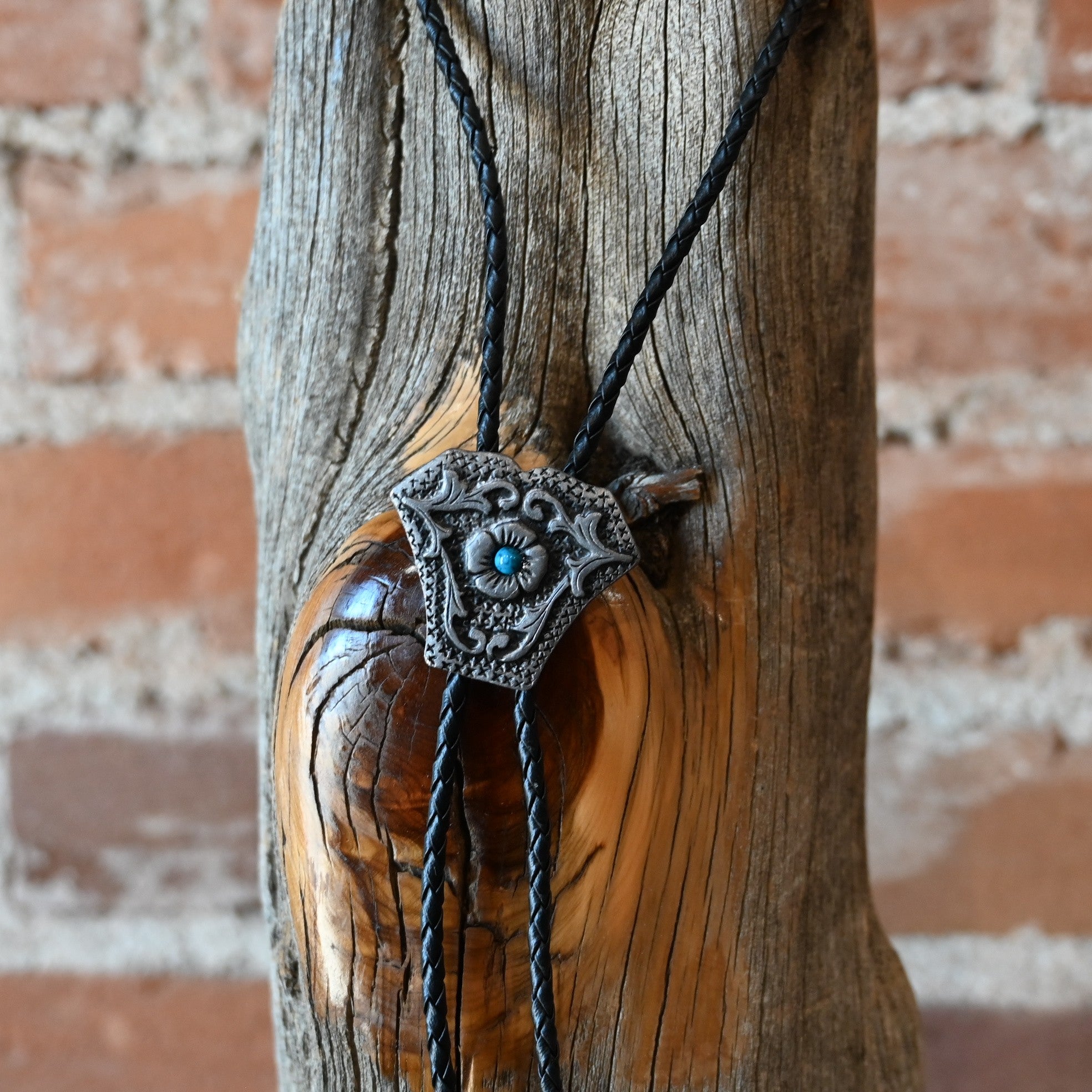 Rockmount Ranch Wear Shield Bolo with stone center and silver tips on black braided leather cord