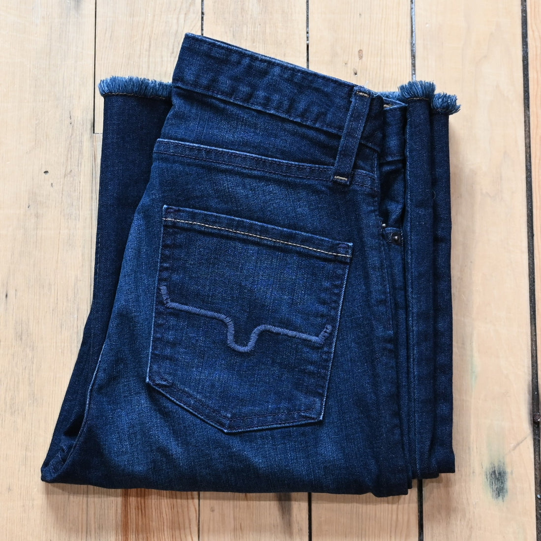 Kimes Ranch Olivia dark wash wide-leg jeans with raw hem and high-rise fit.