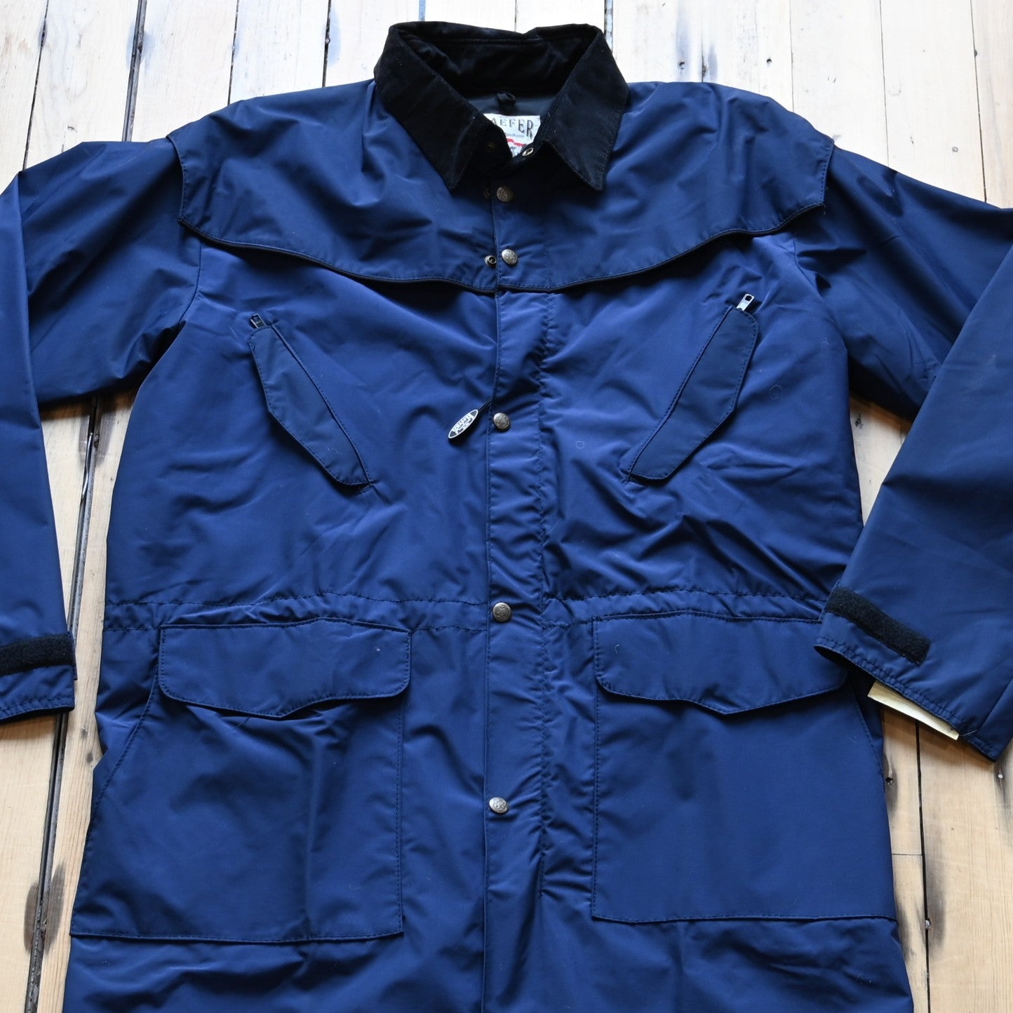 View of Navy waterproof Stockman duster by Schaefer with leather collar and storm flap
