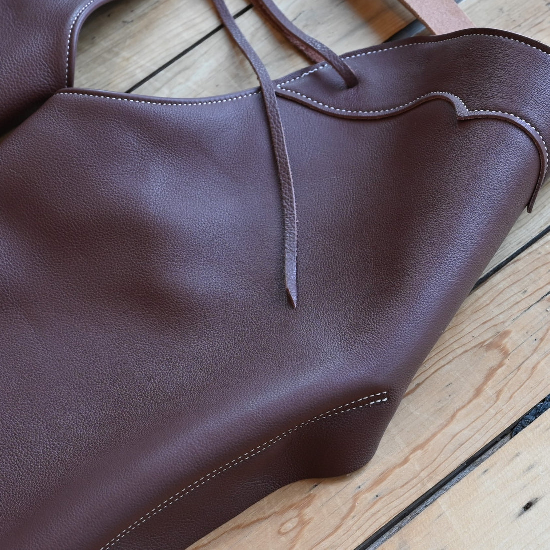 View of Weaver Shotgun Full Grain Chaps in brown oil-tanned leather with adjustable closures