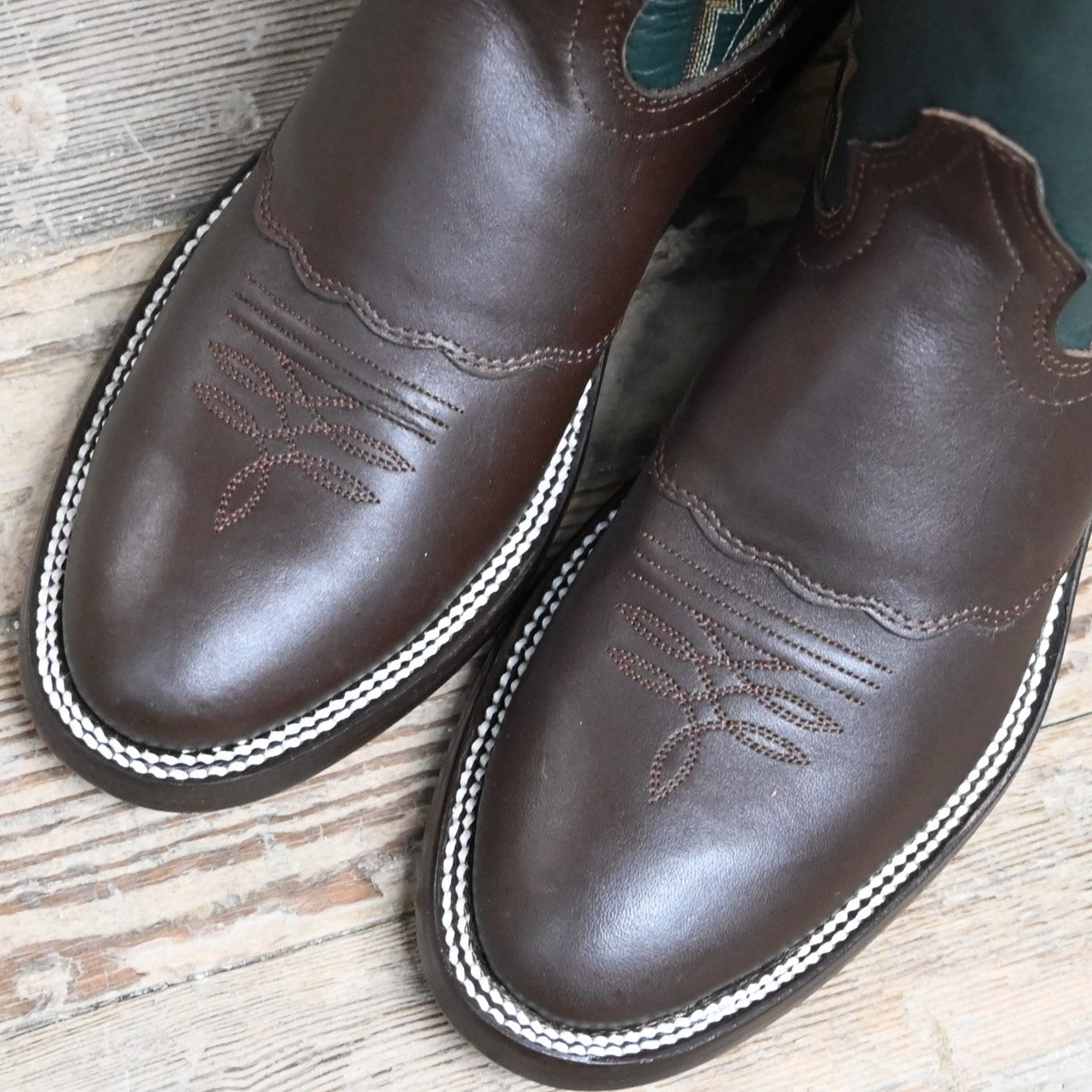 View of Hondo 16" cowboy boot with forest green top, brown retan vamp, pull holes, and double welt stitch