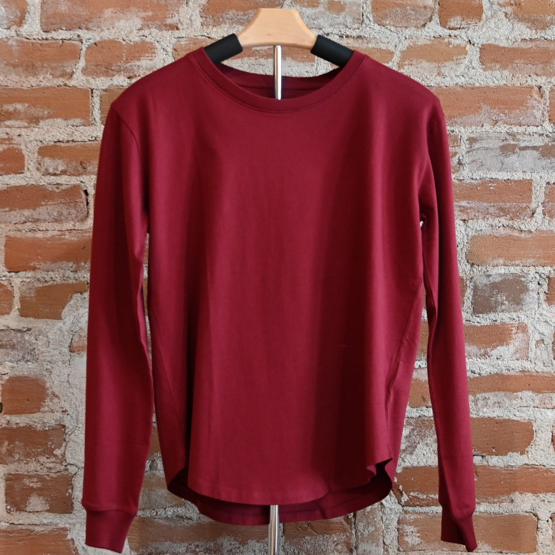 View of Pendleton long sleeve Deschutes Tee in Bay Blue and Cabernet with curved hem